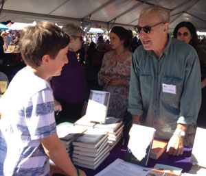 Author Todd Strasser discussing his books with a young fan.