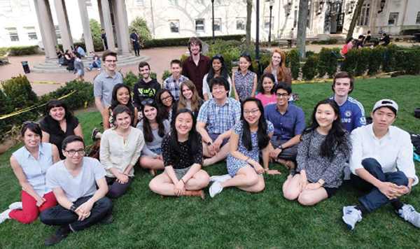 Chloe (seated center in gray top, with sunglasses on her head) with classmates/friends at Columbia University