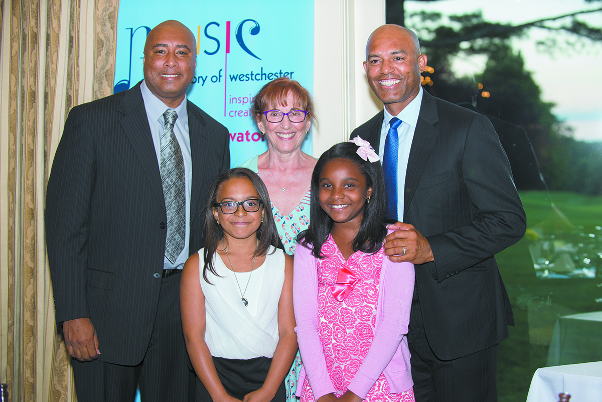 Bernie Williams (left), Conservatory Executive Director Jean Newton (center), and Mariano Rivera with the first recipients of the Clara and Mariano Rivera Music Scholarship, Dyana Taylor Garcia (left) and Mia Sarai Suarez (right).