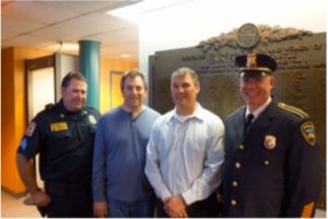 North Castle Police Department Sergeant Timothy See (left) and Chief of Police Peter Simonsen (right) received a Stayin’ Alive Inc. grant during a recent North Castle Town Board meeting. e police were pictured with Andrew Berliner and Doug Saltstein.