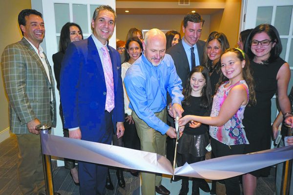 New Castle Town Supervisor Robert Greenstein leads a ribbon cutting during Platinum Drive Realty’s First Open House celebration in early February.