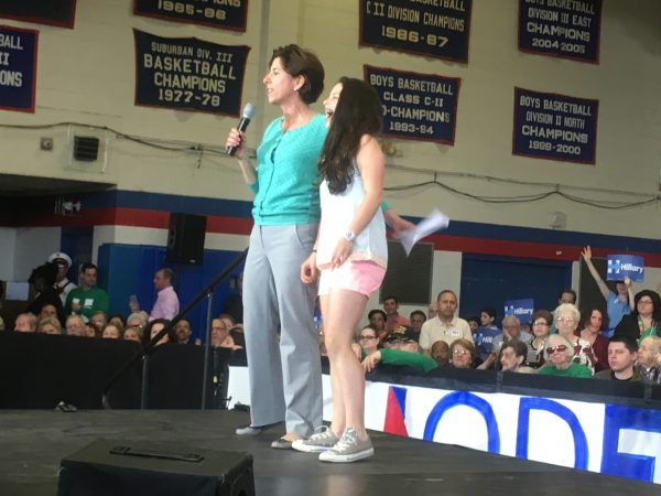 Rhode Island Gov. Gina Raimondo talks to Hillary Clinton supporters at a rally in Central Falls, RI, with her 11-year-old daughter Ceci at her side. 